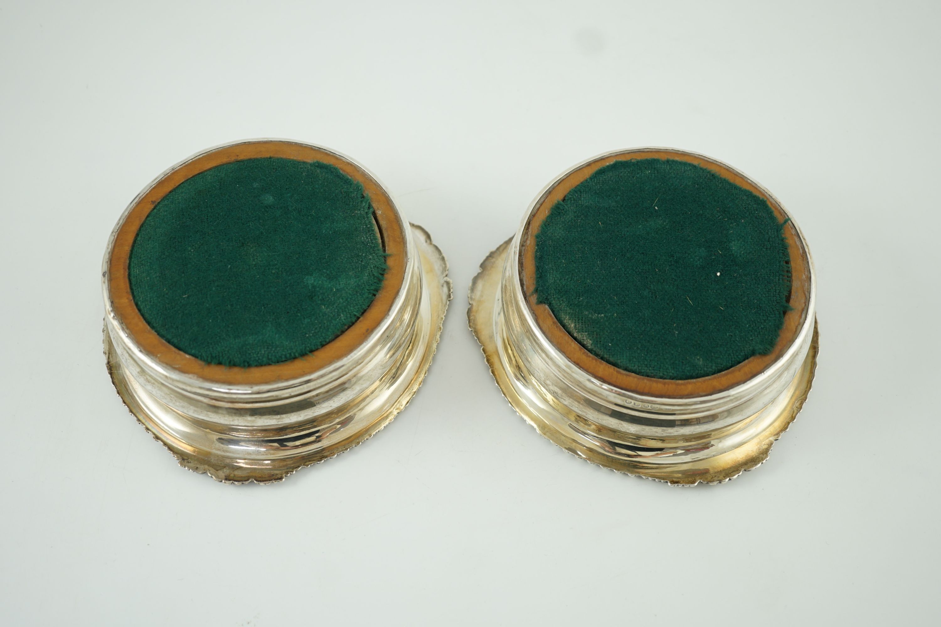 A pair of George IV silver wine coasters by Benjamin Smith III